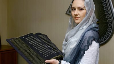 بالصور.. سيدة تصنع أول مصحف مكتوب على الحرير في العالم